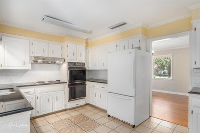 Kitchen featuring decorative backsplash, white cab