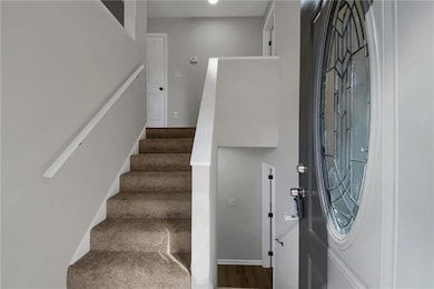 Entryway featuring stairway and dark wood finished floors