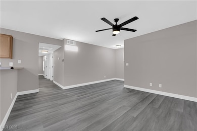 Spare room featuring baseboards, wood finished flo