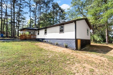 View of home's exterior with a yard and a wooden deck
