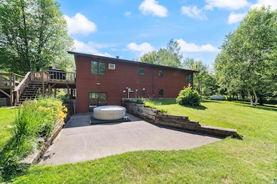 Rear view of property with a patio, stairway, a deck, and a lawn
