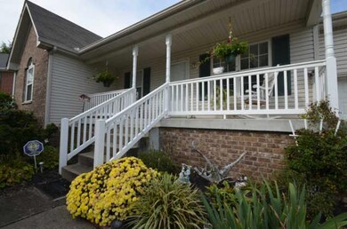 Well Mainicured Yard With Covered Rocking Chair Front Porch