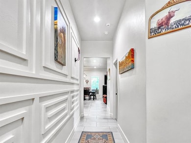 Corridor with light tile patterned floors and recessed lighting