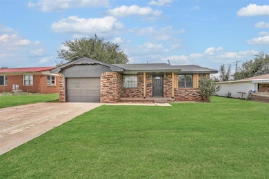 Brick home in Sayre, OK with garage, front porch and concrete driveway