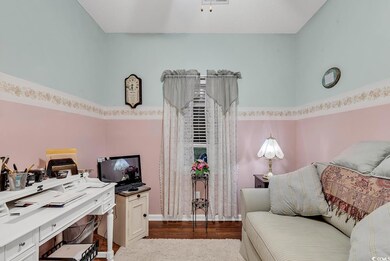Home office with dark hardwood / wood-style floori