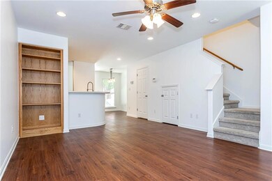 Unfurnished living room featuring stairs, dark wo