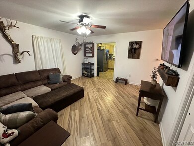 Living room with light hardwood / wood-style floor
