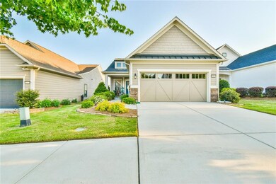 Craftsman-style home with concrete driveway, a sta