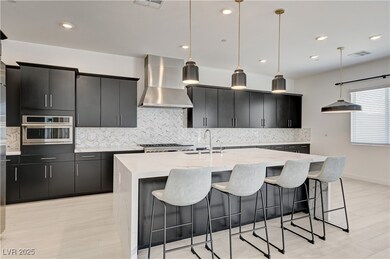 Kitchen with wall chimney range hood, tasteful bac