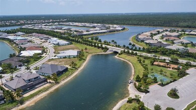 Birds eye view of property with a water view
