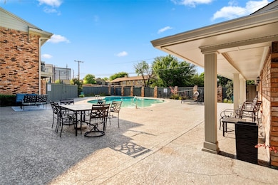 View of pool with outdoor dining space, a fenced b