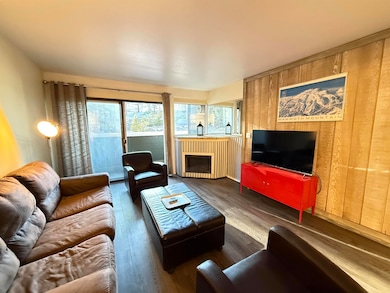 Living area featuring LVP flooring and wood walls