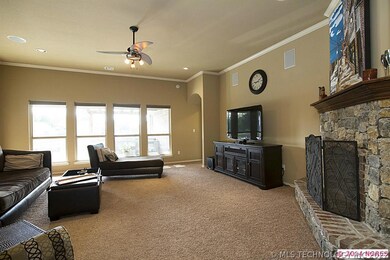 Great room has corner stone gas fireplace with ele