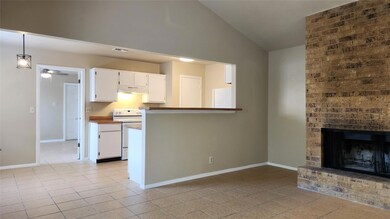 Kitchen featuring white range with electric cookt