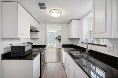 Upgraded kitchen with wood-look tile, new counters