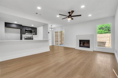 Unfurnished living room with a ceiling fan, reces