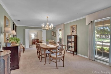 Carpeted dining room with an inviting chandelier, 