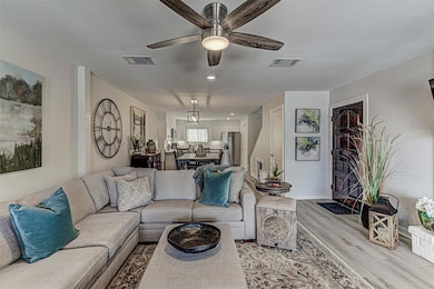 Living room featuring wood finished floors, ceiling fan, and recessed lighting