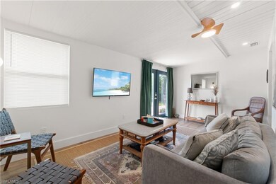 Living room with hardwood / wood-style flooring, wood ceiling, and beam ceiling