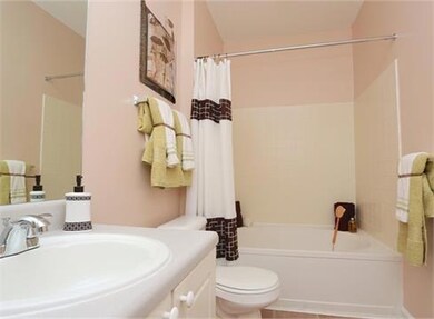 Full bathroom with vanity, toilet, shower / tub combo with curtain, and vaulted ceiling
