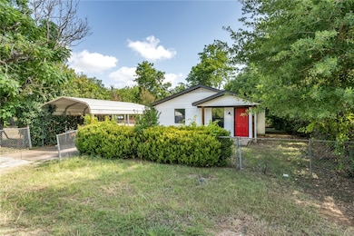 View of front facade with a carport and a gate