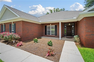 Property entrance featuring brick siding, board and batten siding, roof with shingles, and covered porch