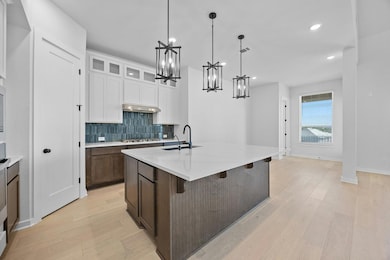 Kitchen featuring a chandelier, stainless steel g
