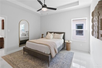 Principal's Bedroom featuring high ceiling, a ceiling fan