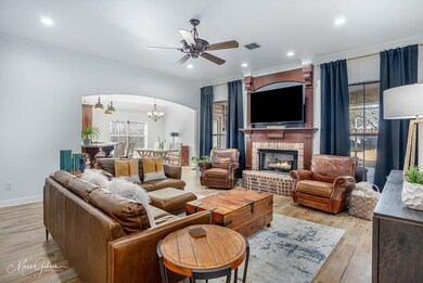 Living room featuring ornamental molding, a firepl