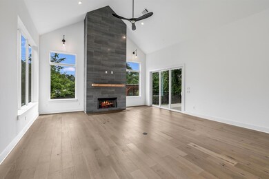 Unfurnished living room featuring high vaulted ce