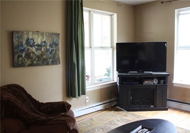 Another view of living room showing second window,