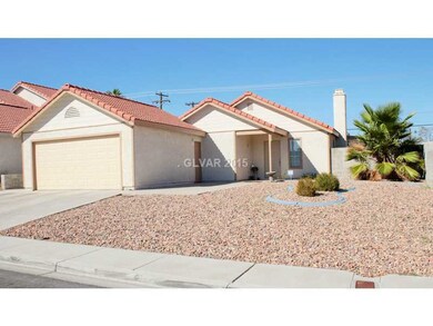 Facade/Exterior Front. Rocks desert landscaping.
