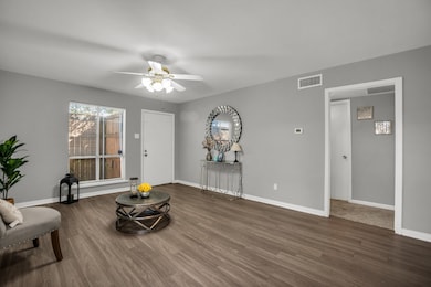 Living area featuring with new  floors and ceiling fan.