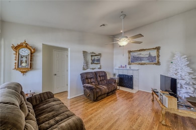 Living area with a fireplace, wood finished floors