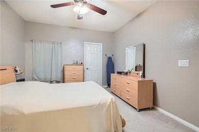 Bedroom featuring light colored carpet and a ceiling fan