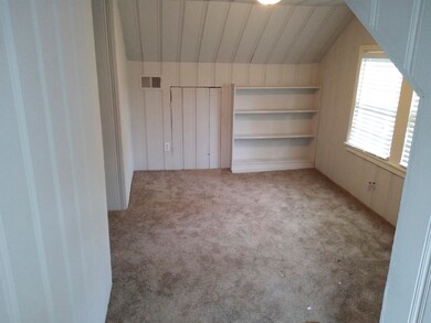 Additional living space featuring lofted ceiling a