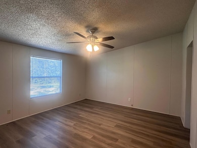 Spare room featuring wood finished floors, a text