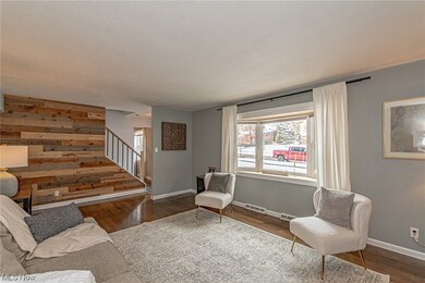 Living room featuring dark hardwood / wood-style floors and wood walls