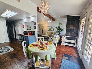 Dining room with dark wood-type flooring, crown m