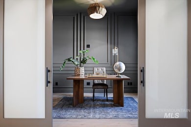 Office featuring wood finished floors and a decorative wall