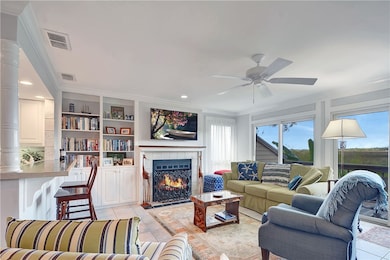 Great room with fireplace - expansive windows to e
