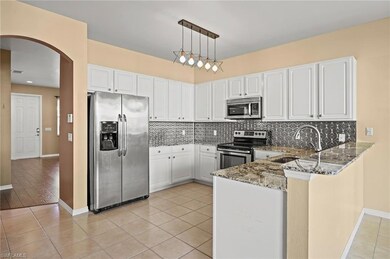 Kitchen with stone countertops, sink, decorative l
