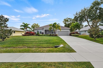 Ranch-style house with concrete driveway, a front lawn, a garage, and stucco siding
