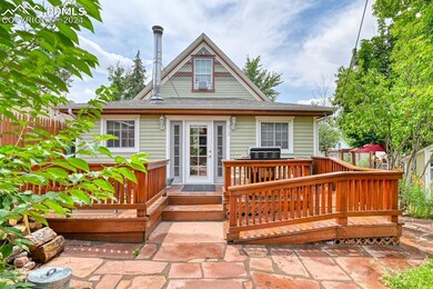 Rear view of property with a wooden deck and a pat