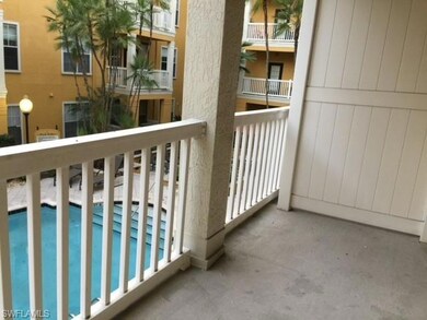 Balcony featuring view of pool area