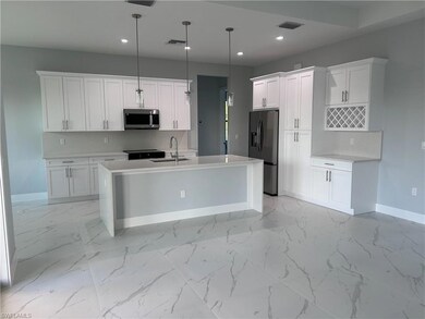 Kitchen with stainless steel microwave, refrigerat