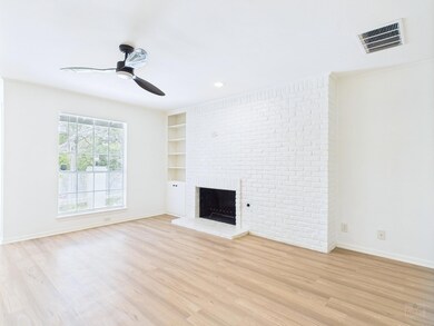 Unfurnished living room with a ceiling fan, a bri
