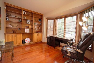 the office with built in cabinetry, gorgeous hardw