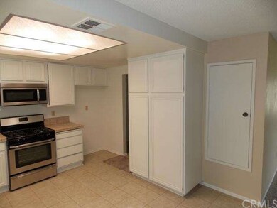 Kitchen with large pantry and tile floors