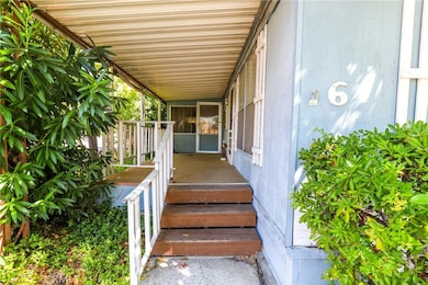 Steps lead you up to the covered front porch.